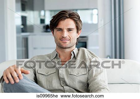 Man in living room, portrait View Large Photo Image Stock Image - Man in living room, portrait. Fotosearch
