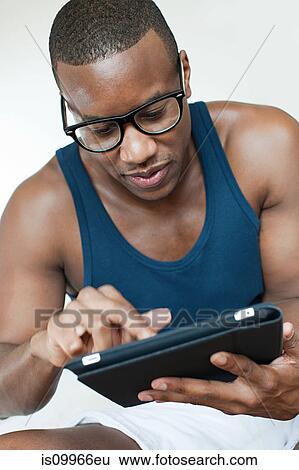 Man using digital tablet View Large Photo Image Stock Photograph - Man using digital tablet. Fotosearch