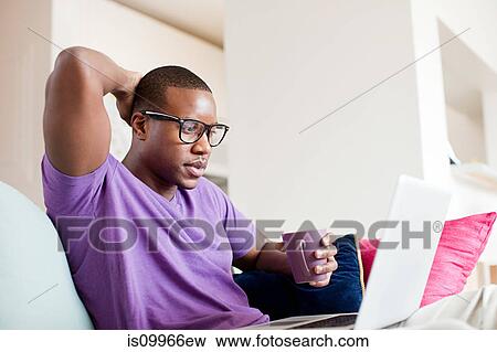 Man using laptop View Large Photo Image Stock Photo - Man using laptop. Fotosearch