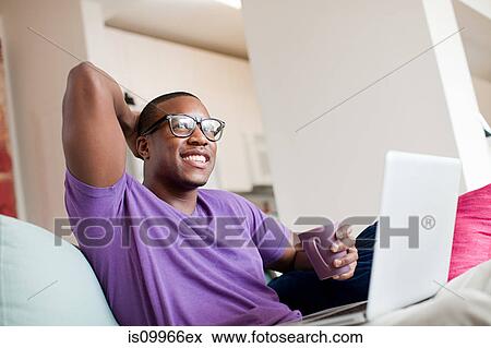 Man using laptop View Large Photo Image Stock Photo - Man using laptop. Fotosearch