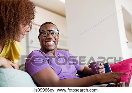 Man using laptop woman looking over his shoulder View Large Photo Image Stock Photo - Man using laptop woman looking over his shoulder. Fotosearch