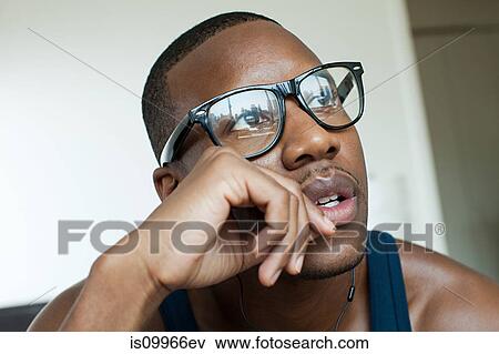 Man wearing glasses, contemplating View Large Photo Image Stock Photo - Man wearing glasses, contemplating. Fotosearch