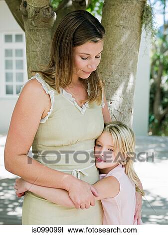 Mother and daughter embracing by tree View Large Photo Image Stock Image - Mother and daughter embracing by tree. Fotosearch