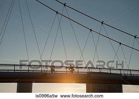 Stock Photo - Pedestrian bridge over Main River at sunset, Frankfurt, Germany. Fotosearch