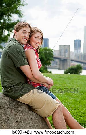 Stock Photograph - Portrait of young couple in city park. Fotosearch