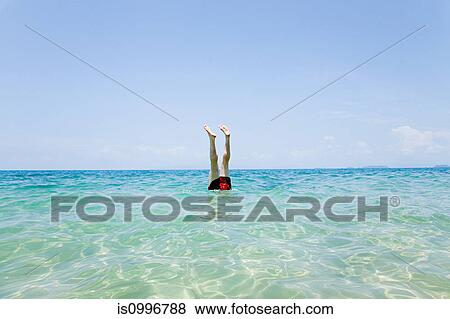 Swimmer with legs sticking out of water off Penhentian Kecil, Perhentian Islands, Malaysia View Large Photo Image Stock Photo - Swimmer with legs sticking out of water off Penhentian Kecil, Perhentian Islands, Malaysia. Fotosearch