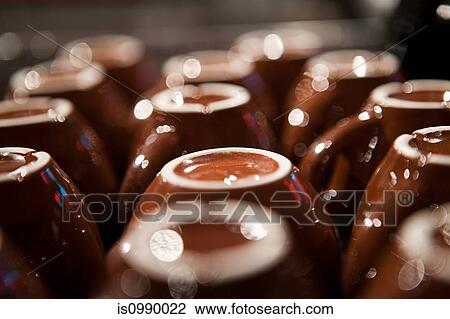 Stock Image - Upside down coffee cups, close up. Fotosearch