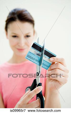 Woman cutting credit card with pair of scissors View Large Photo Image Stock Photo - Woman cutting credit card with pair of scissors. Fotosearch