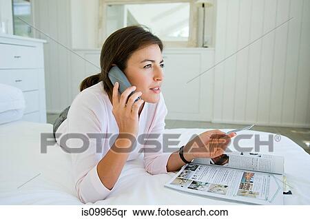 Woman home shopping on phone with credit card View Large Photo Image Stock Photography - Woman home shopping on phone with credit card. Fotosearch