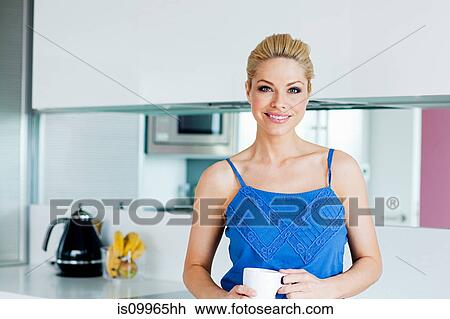 Stock Image - Woman in kitchen, portrait. Fotosearch