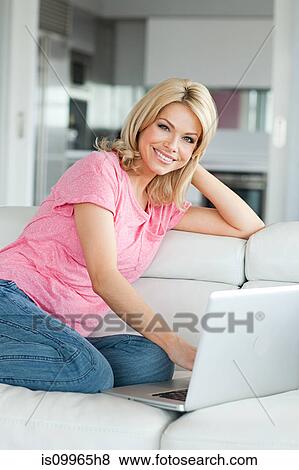 Stock Photo - Woman using laptop, portrait. Fotosearch