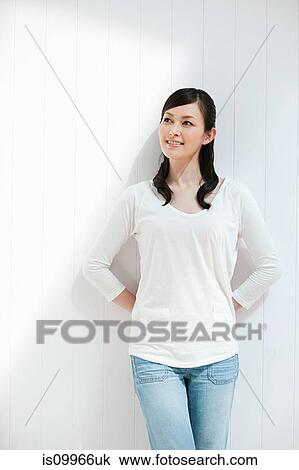 Stock Image - Woman wearing white top, portrait. Fotosearch