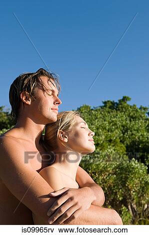 Young couple embracing, eyes closed View Large Photo Image Stock Photo - Young couple embracing, eyes closed. Fotosearch