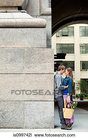 Stock Image - Young couple embracing outdoors. Fotosearch