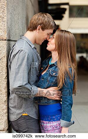 Young couple kissing outdoors View Large Photo Image Stock Image - Young couple kissing outdoors. Fotosearch