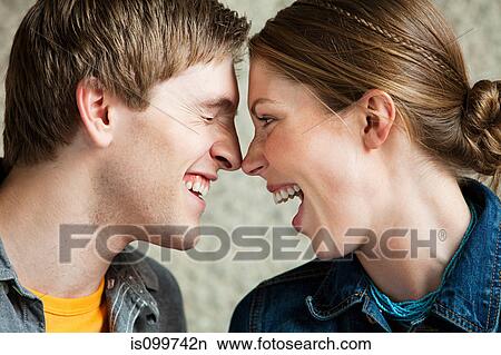 Young couple laughing together View Large Photo Image Picture - Young couple laughing together. Fotosearch