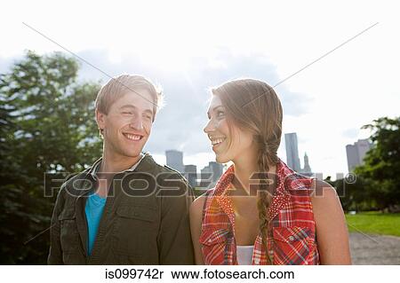 Young couple walking in city park View Large Photo Image Stock Photography - Young couple walking in city park. Fotosearch