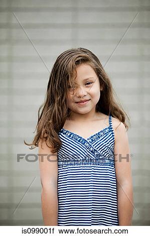 Stock Image - Young girl wearing sundress, portrait. Fotosearch