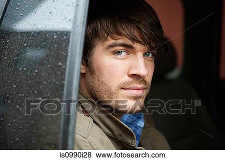Stock Photo - Young man in car, close up. Fotosearch