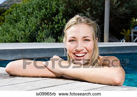 Young woman at poolside, portrait View Large Photo Image Stock Image - Young woman at poolside, portrait. Fotosearch