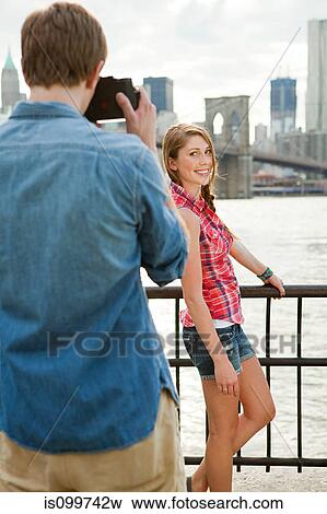 Young woman posing for photograph View Large Photo Image Stock Photo - Young woman posing for photograph. Fotosearch