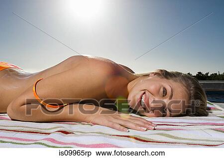Stock Photography - Young woman sunbathing. Fotosearch