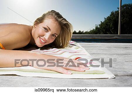 Stock Photography - Young woman sunbathing. Fotosearch