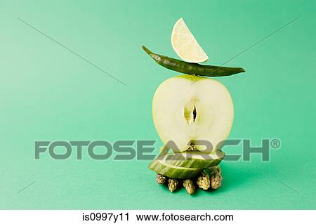Arrangement of apple, asparagus, green chili and cucumber against green background View Large Photo Image Stock Image - Arrangement of apple, asparagus, green chili and cucumber against green background. Fotosearch