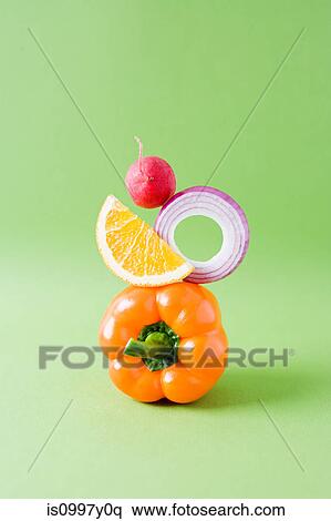 Arrangement of pepper, onion, orange and radish against green background View Large Photo Image Stock Photography - Arrangement of pepper, onion, orange and radish against green background. Fotosearch
