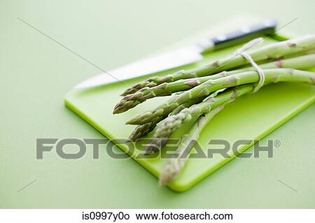 Asparagus on chopping board View Large Photo Image Picture - Asparagus on chopping board. Fotosearch