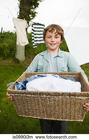 Boy carrying washing basket View Large Photo Image Picture - Boy carrying washing basket. Fotosearch