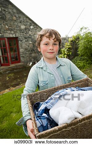 Boy carrying washing basket View Large Photo Image Stock Image - Boy carrying washing basket. Fotosearch