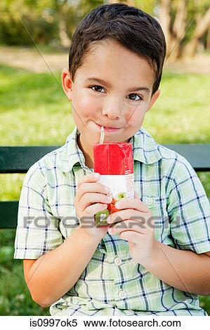 Boy drinking from juice carton, portrait View Large Photo Image Stock Photography - Boy drinking from juice carton, portrait. Fotosearch