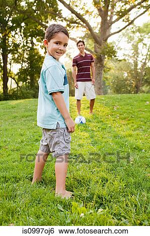 Boy in park with father, smiling View Large Photo Image Stock Photograph - Boy in park with father, smiling. Fotosearch