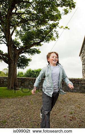 Boy running across gravel View Large Photo Image Stock Photograph - Boy running across gravel. Fotosearch