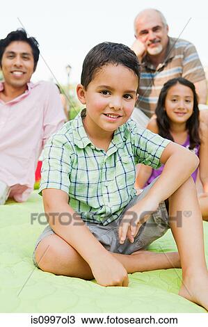Boy smiling with famil in park, portrait View Large Photo Image Stock Image - Boy smiling with famil in park, portrait. Fotosearch