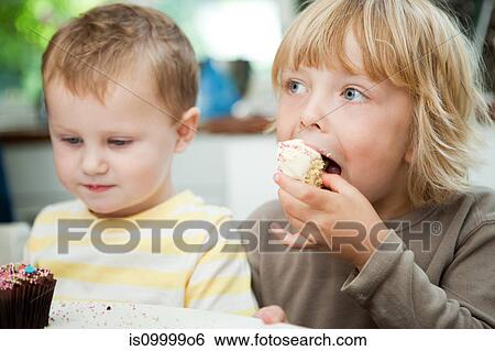 Boys eating cupcakes View Large Photo Image Stock Photograph - Boys eating cupcakes. Fotosearch
