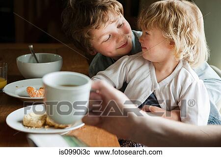 Brother and sister having breakfast View Large Photo Image Stock Image - Brother and sister having breakfast. Fotosearch