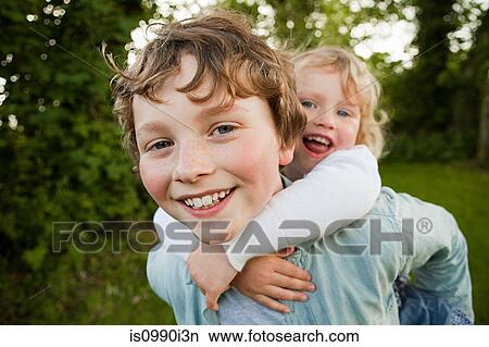 Picture - Brother giving sister piggyback. Fotosearch