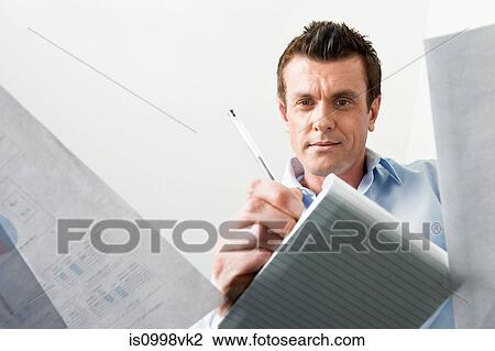 Business man writing in a notebook View Large Photo Image Stock Image - Business man writing in a notebook. Fotosearch
