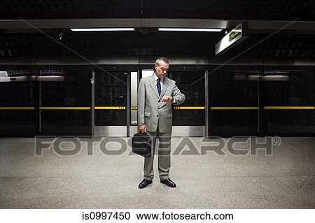 Businessman waiting on subway platform View Large Photo Image Stock Image - Businessman waiting on subway platform. Fotosearch