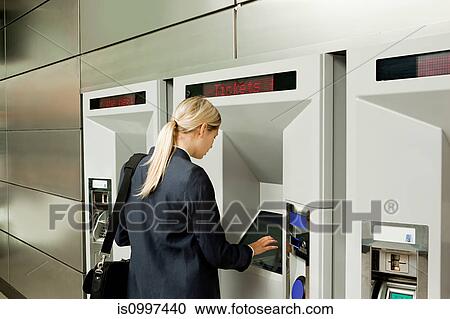 Businesswoman buying a train ticket View Large Photo Image Stock Image - Businesswoman buying a train ticket. Fotosearch