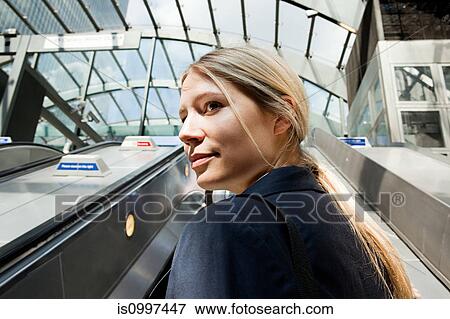 Businesswoman on subway escalators View Large Photo Image Stock Photo - Businesswoman on subway escalators. Fotosearch