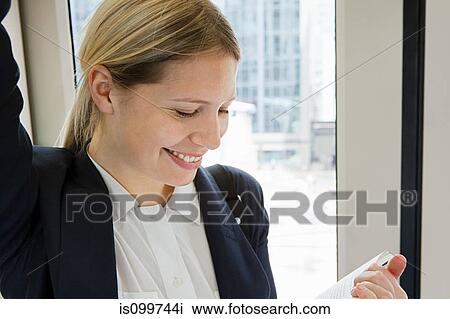Businesswoman travelling on train View Large Photo Image Stock Image - Businesswoman travelling on train. Fotosearch