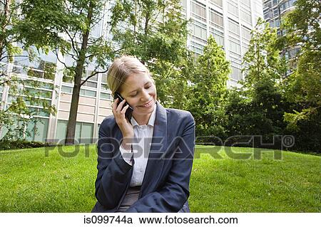 Businesswoman using cellphone outdoors View Large Photo Image Stock Image - Businesswoman using cellphone outdoors. Fotosearch