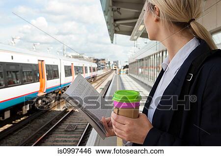 Stock Photograph - Businesswoman waiting for train. Fotosearch