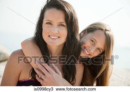 Close up of a mother and daughter embracing View Large Photo Image Stock Image - Close up of a mother and daughter embracing. Fotosearch