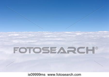 Stock Photograph - Cloudscape against blue sky. Fotosearch