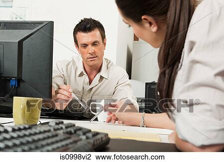 Colleagues reviewing work together View Large Photo Image Stock Image - Colleagues reviewing work together. Fotosearch