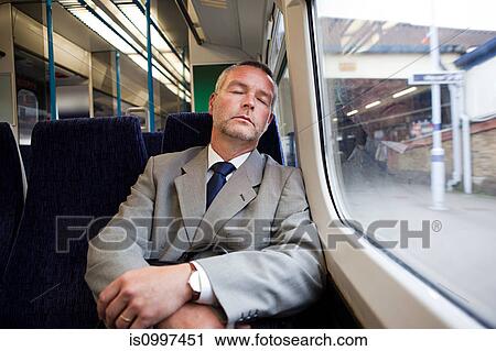 Commuter asleep on train View Large Photo Image Stock Image - Commuter asleep on train. Fotosearch